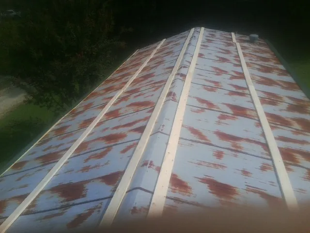 Rusted metal roof panels with new wood purlins before replacement — Storm Damage Roof Repair in Long Valley by Roofing Brothers